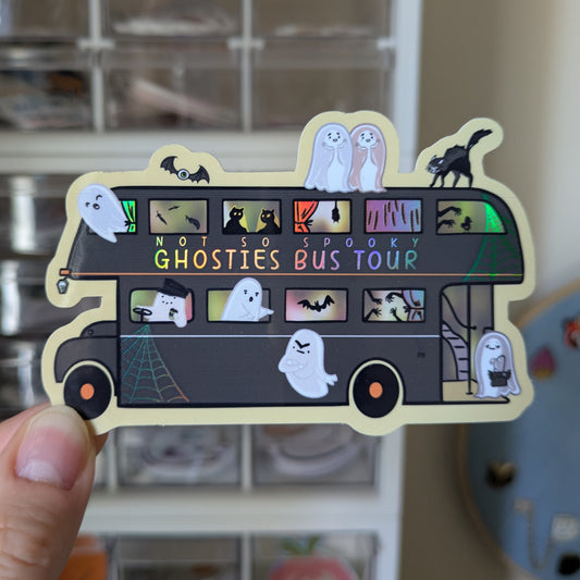 Sticker of a bus with ghosts and Halloween elements, labeled 'Not So Spooky Ghosties Bus Tour'